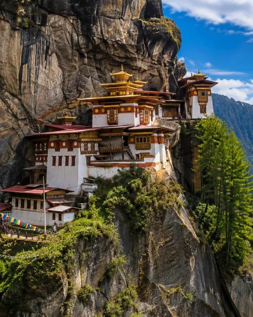 The Taktsang monastery on its cliff above the Paro valley, prayer flags in front