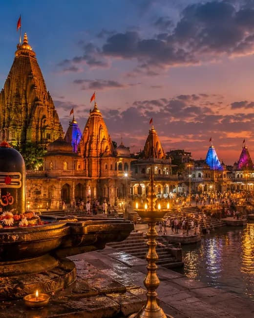 Lit temple spires along the river ghats at sunset
