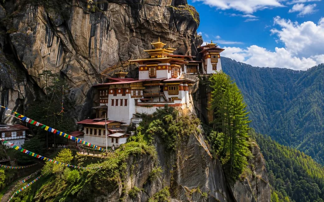 The Taktsang monastery on its cliff above the Paro valley, prayer flags in front