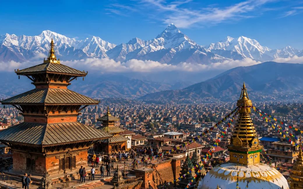 A pagoda temple and stupa above the Kathmandu valley, the Himalaya behind