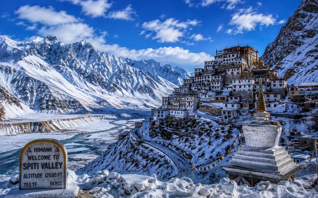 Key Monastery under snow, beside the sign at the entrance to the Spiti valley